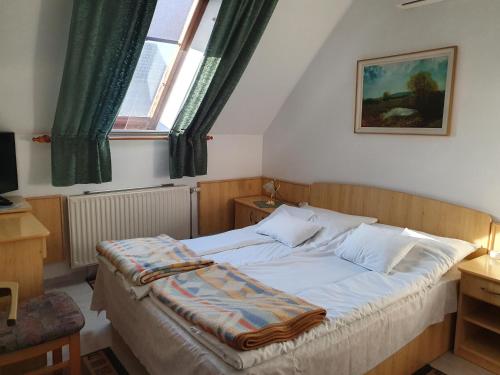 מיטה או מיטות בחדר ב-Gála Panzió
