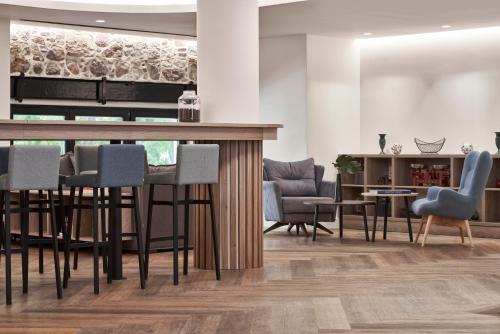 
a living room filled with chairs and tables at NLH MONASTIRAKI - Neighborhood Lifestyle Hotels in Athens
