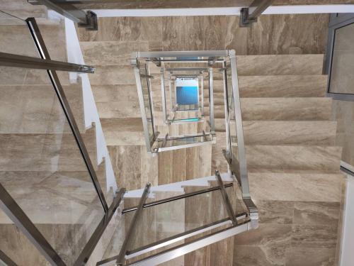 a stairwell in a building with glass and stone walls at Hotel Pautalia in Sunny Beach