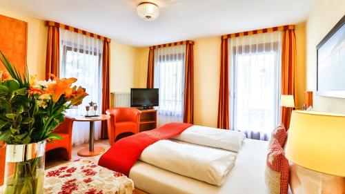 Habitación de hotel con cama, escritorio y ventana en Hotel Bischoff en Baden-Baden