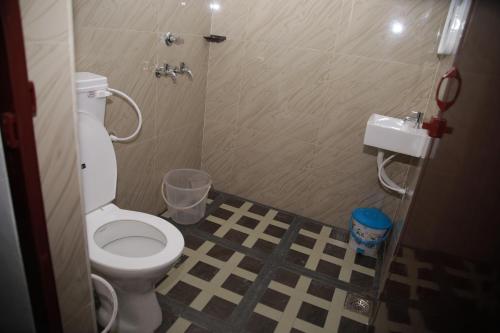 a bathroom with a white toilet and a shower at MEGHNA RESIDENCY in Trivandrum