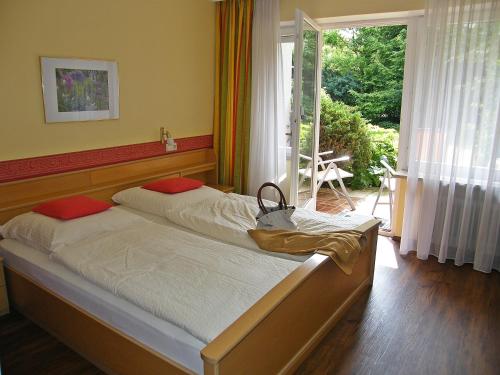 a bedroom with two beds and a large window at Landhaus Oberrainer in Bad Griesbach
