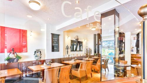 a restaurant with wooden tables and chairs in a room at Hotel Laterne in Baden-Baden