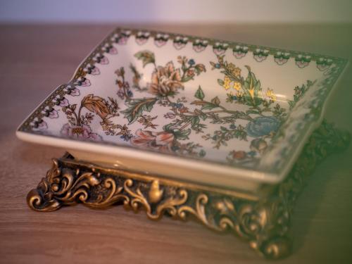 a plate with flowers on it sitting on a table at ȘURA LU' PĂTRU in Vulcan