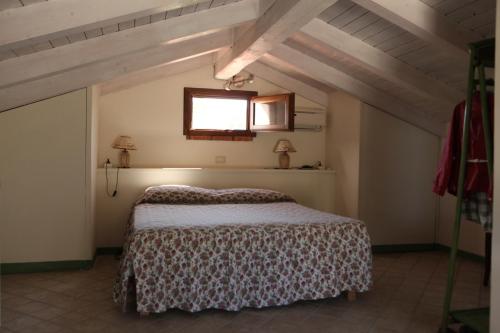 a bedroom with a bed and a window at Agriturismo Il Pozzo in Casal Velino