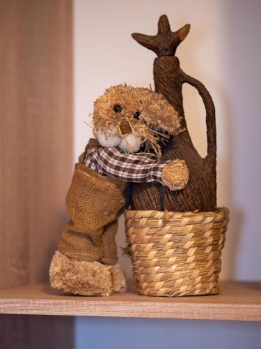 a teddy bear in a basket with a rabbit on it at ȘURA LU' PĂTRU in Vulcan