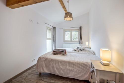 a bedroom with a bed and a table and a window at Maison de 2 chambres avec jardin a La Bollene Vesubie in La Bollène-Vésubie