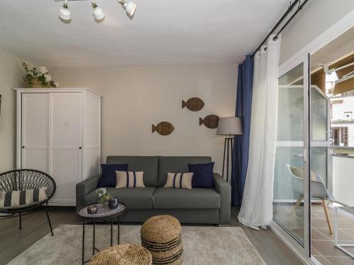 a living room with a couch and a table at Sitges Spaces Deluxe Centre Apartment in Sitges