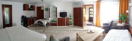 a living room with a couch and a table at Appartement auf Rügen in Sagard