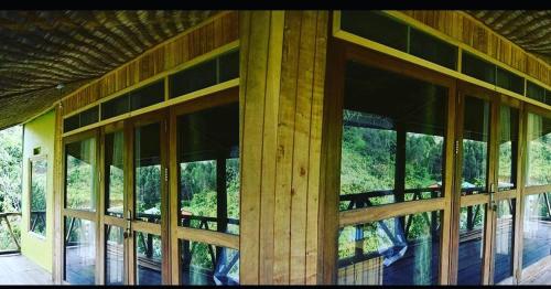 a building with windows on the side of it at Gorilla Hills Eco-lodge in Kisoro