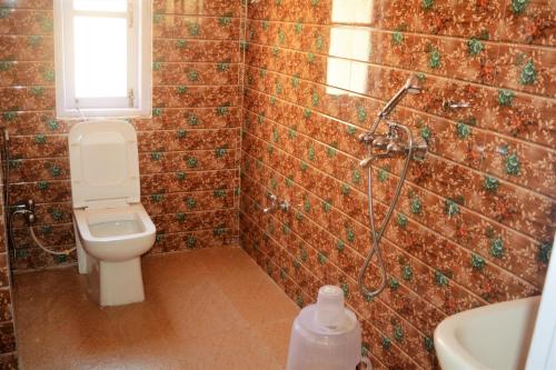 a bathroom with a toilet and a shower at Rufina Lachung de'CROWN in Lachung