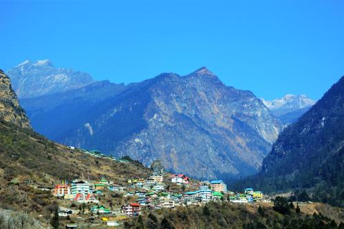 a small town on a hill in the mountains at Rufina Lachung de'CROWN in Lachung