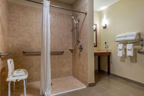 a bathroom with a shower with a glass door at Comfort Suites Niceville Near Eglin Air Force Base in Niceville