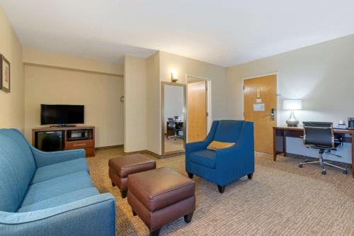 a living room with a couch and chairs and a desk at Comfort Inn Mechanicsburg - Harrisburg South in Mechanicsburg