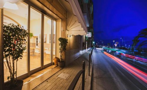 a city street at night with a street light at Hotel Alfiero in Porto Santo Stefano