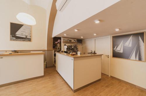 a room with a kitchen with a counter top at Hotel Alfiero in Porto Santo Stefano