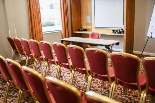 a conference room with a table and chairs at Holiday Inn Express Antrim by IHG in Antrim