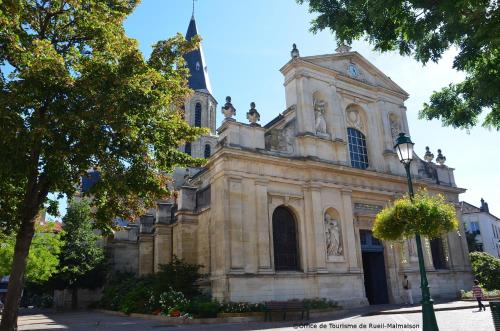 an old church with a steeple and a street light at ibis Rueil-Malmaison Centre in Rueil-Malmaison