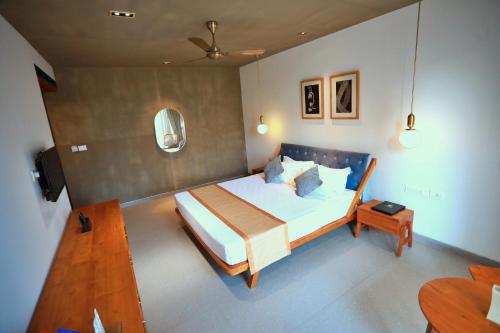 a bedroom with a large bed and a table at E.05 City Inn in Alwaye