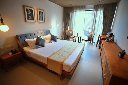 a bedroom with a large bed in a room at E.05 City Inn in Alwaye