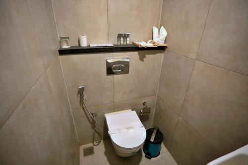 a small bathroom with a toilet and a sink at E.05 City Inn in Alwaye