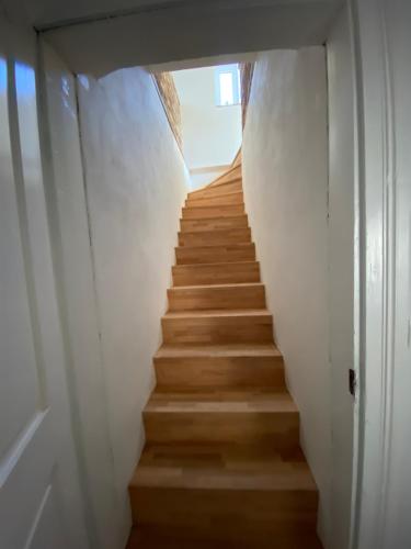a staircase leading up to a room with white walls at Chalupa U Berušek in Oskava