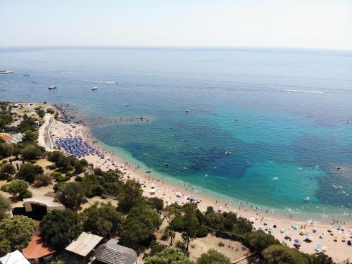 an aerial view of a beach with people in the water at Club Esse Cala Gonone in Cala Gonone