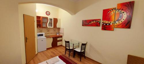 a kitchen with a table and chairs in a room at Penzión Korzo in Štúrovo