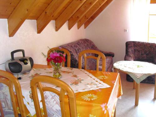 a table and chairs with a vase of flowers on it at Farmhouse Escape in Hofstetten in Hofstetten