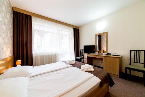 Ένα ή περισσότερα κρεβάτια σε δωμάτιο στο Hotel Muresul Health Spa