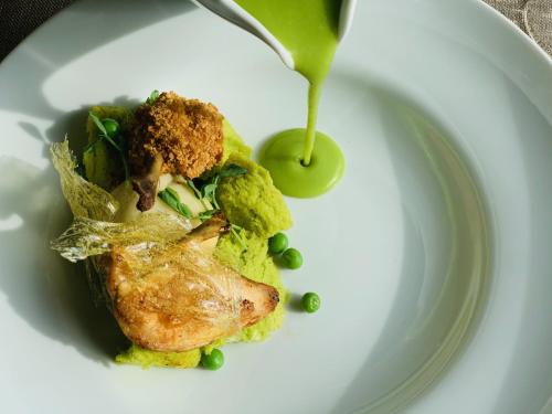 a plate of food with a piece of meat and vegetables at Barack Thermal Hotel and Spa in Tiszakécske