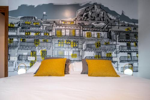 a bedroom with a wall mural of a building at LA CASETA Turismo Rural in Morella