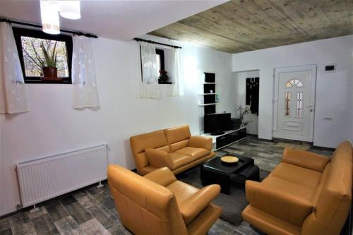 a living room with two chairs and a couch and a table at Maria*s Apartment! in Cristian