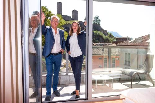 a man and a woman standing on a balcony at Hotel Unione in Bellinzona