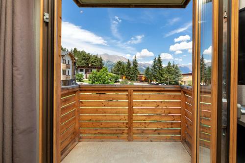 a view from the balcony of a house with a large window at SOWELL RESIDENCES Pra Loup in Pra-Loup