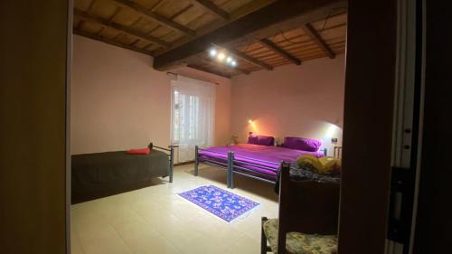 a bedroom with a purple bed and a window at Antica Cascina B&B in Borghetto Lodigiano