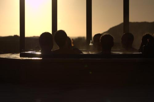 a group of people in a hot tub at sunset at Hav & Logi Skärhamn in Skärhamn