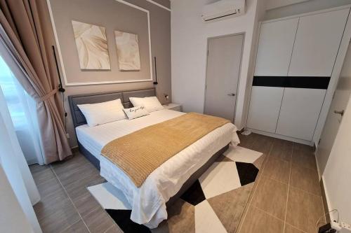 a bedroom with a large bed in a room at Mizrai Troika Homestay with Kota Bharu city view in Kota Bharu