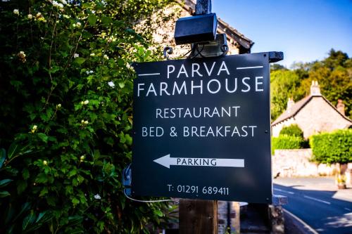 a sign for a farmhouse restaurant and breakfast at Parva Farmhouse Riverside Guesthouse in Tintern