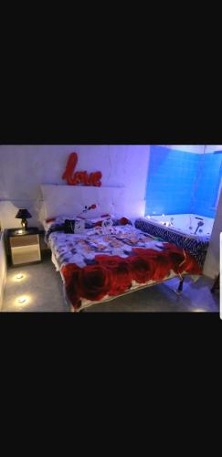 a bedroom with a bed with a red writing on it at Hotel Napoleon-Cuore in Qualiano