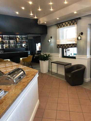 a kitchen with a counter and a table at Avila Park & SPA in Dziwnówek