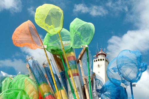 a lighthouse with a bunch of umbrellas in front of it at Noordwijk Holiday Rentals in Noordwijk