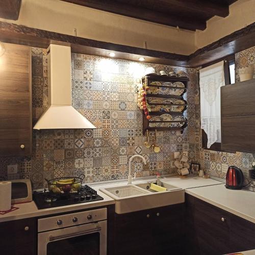a kitchen with a sink and a stove at Areti's Traditional house in Apóllona
