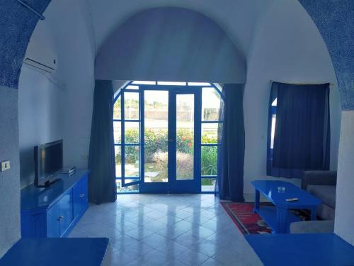 a living room with a large window and a room with blue walls at New Panorama Resort in Fayoum Center