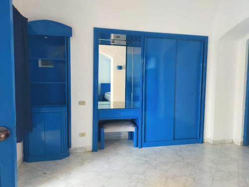 a blue bathroom with a mirror and a blue cabinet at New Panorama Resort in Fayoum Center
