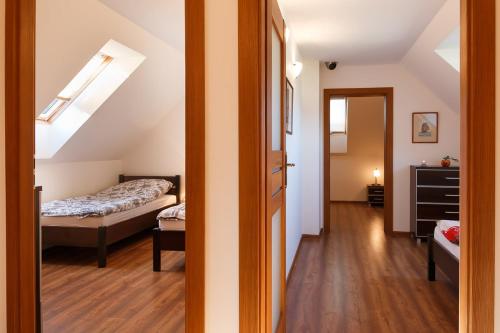 a bedroom with a bed and a room with a window at Luxury Lakehouses in Brodnica Lake District in Brodnica