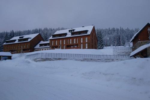 a building with snow on top of it at Apartmán Horní Mísečky - luxusní ubytování pro dvě rodiny s dětmi in Horni Misecky