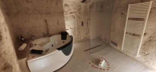 a bathroom with a bath tub and a shower at 5 Elementi Sassi Matera in Matera