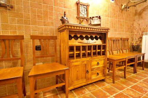a wine tasting room with wooden chairs and a wooden cabinet at Pensiunea Nordica in Statiunea Borsa