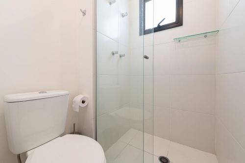 a bathroom with a toilet and a glass shower at Tag Decor in Sao Paulo